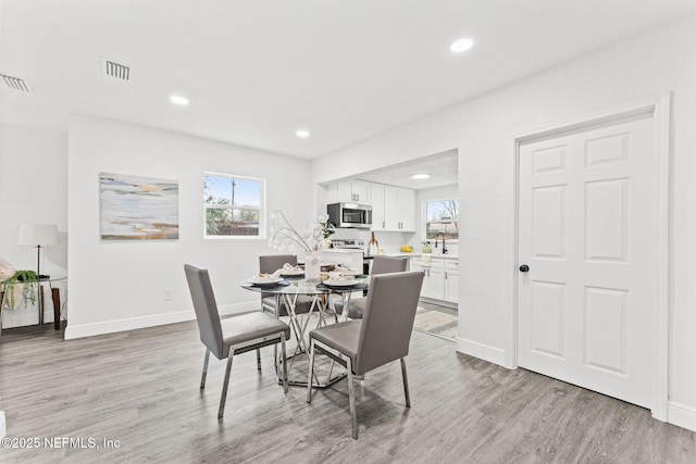 dining room with light hardwood / wood-style flooring