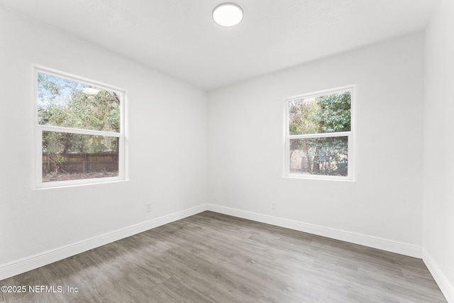 empty room with hardwood / wood-style flooring