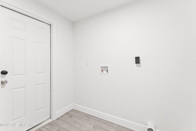 laundry area featuring light hardwood / wood-style floors and washer hookup