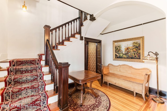 stairs featuring wood-type flooring