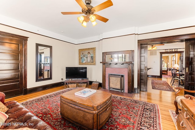 living room featuring hardwood / wood-style flooring and ceiling fan