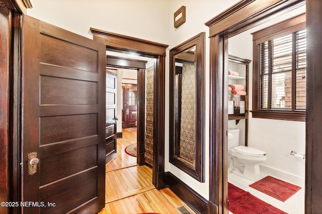 bathroom featuring hardwood / wood-style flooring and toilet