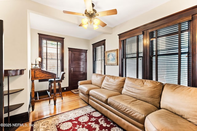 living room with light wood-type flooring and ceiling fan