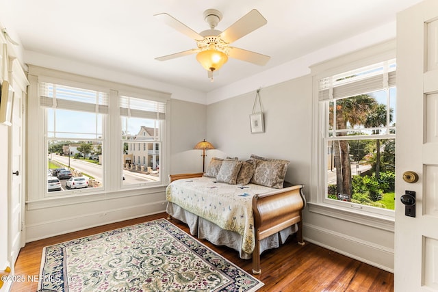 bedroom with ceiling fan and dark hardwood / wood-style flooring