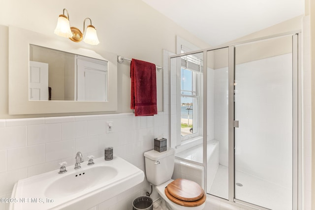 bathroom with sink, tile walls, toilet, walk in shower, and vaulted ceiling