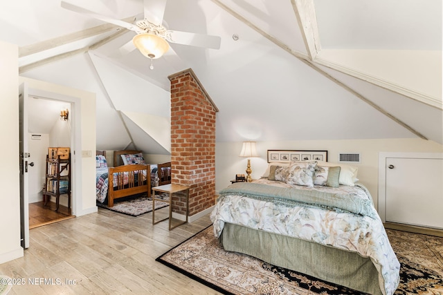 bedroom with vaulted ceiling, ceiling fan, and light hardwood / wood-style floors