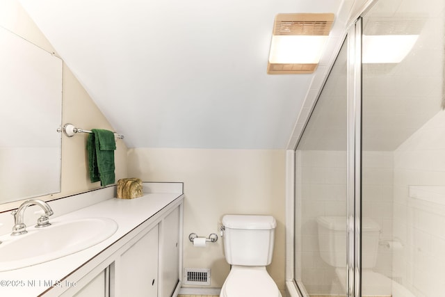 bathroom featuring vanity, vaulted ceiling, walk in shower, and toilet