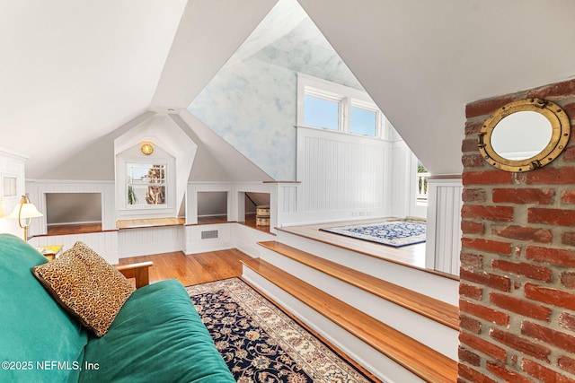 living room with hardwood / wood-style flooring and vaulted ceiling