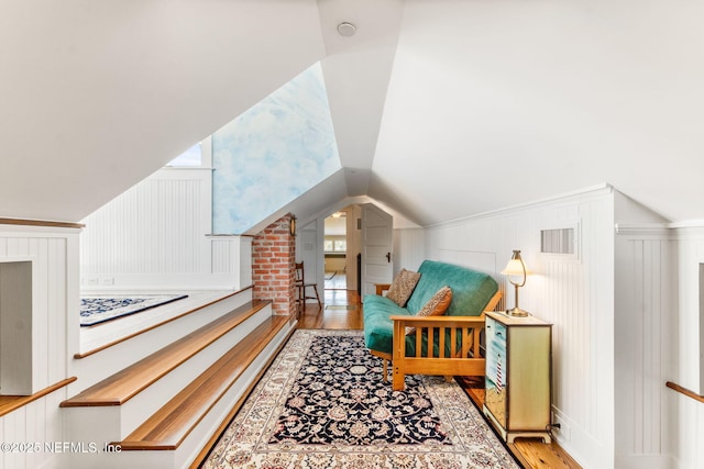 bonus room with light hardwood / wood-style floors and lofted ceiling