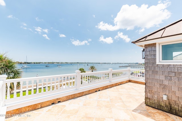 view of patio with a water view