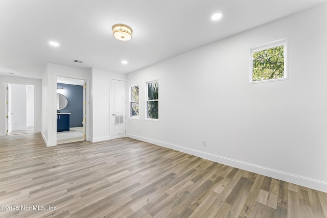 unfurnished room featuring light hardwood / wood-style floors and plenty of natural light