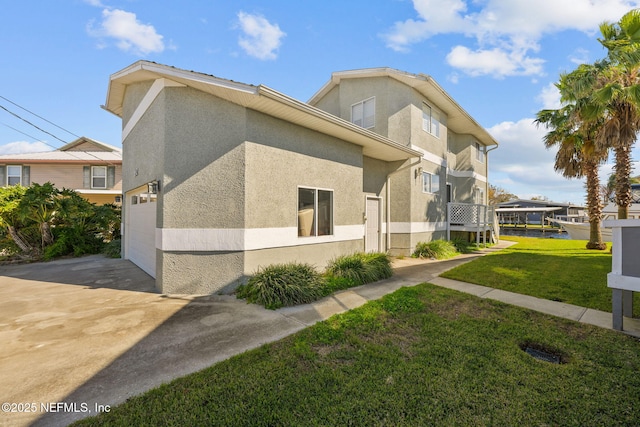 view of property exterior with a garage and a lawn