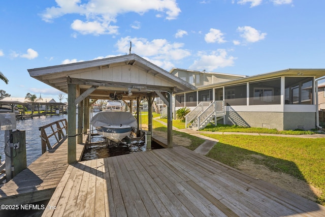 dock area featuring a water view and a lawn