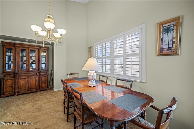 dining space featuring an inviting chandelier, a high ceiling, and light tile patterned floors