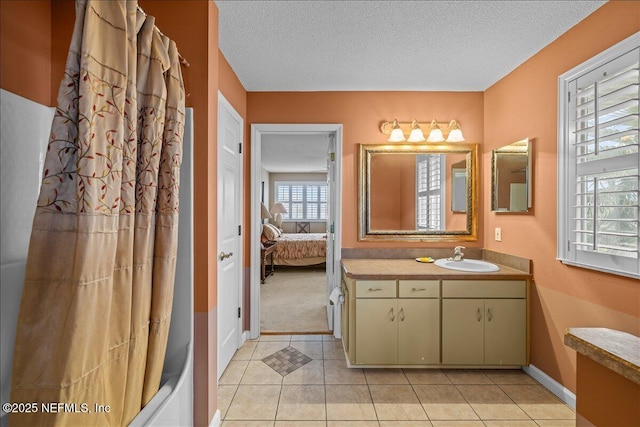 bathroom with tile patterned flooring, vanity, and a textured ceiling