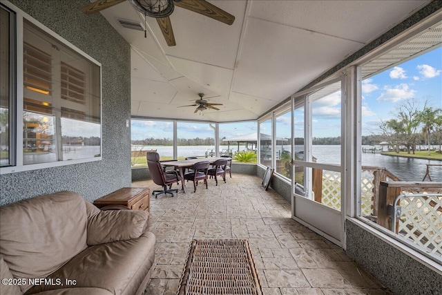 sunroom with a water view, a wealth of natural light, and ceiling fan