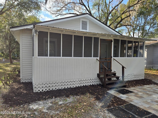 view of front of home with a sunroom