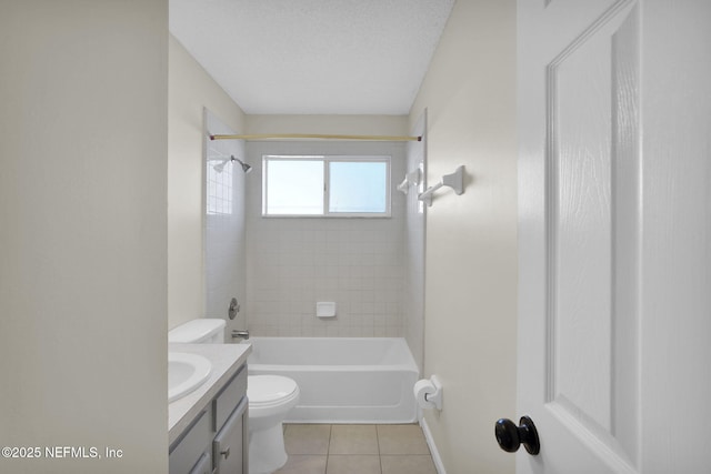 full bathroom featuring a textured ceiling, tiled shower / bath, tile patterned flooring, vanity, and toilet