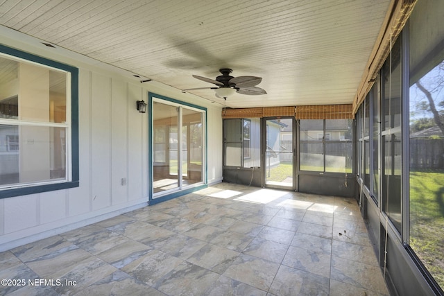 unfurnished sunroom with ceiling fan