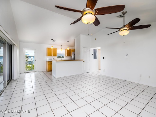 unfurnished living room featuring light tile patterned floors, electric panel, and lofted ceiling