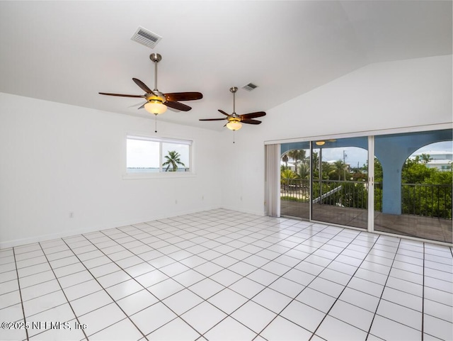 empty room featuring light tile patterned floors and lofted ceiling