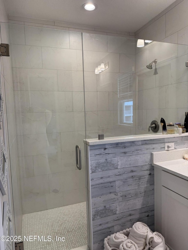 bathroom with an enclosed shower and vanity