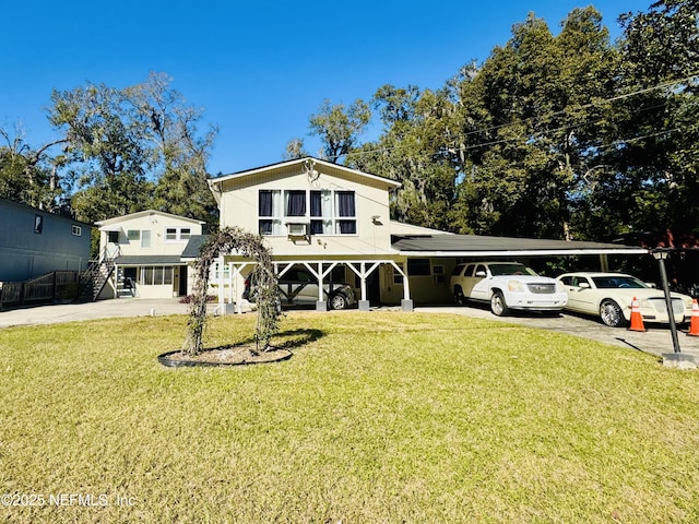 view of front of home with a front lawn and a carport