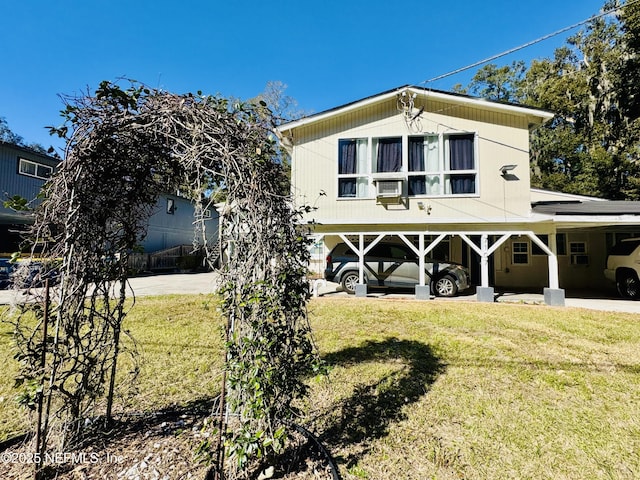 view of front facade with a front lawn and a carport