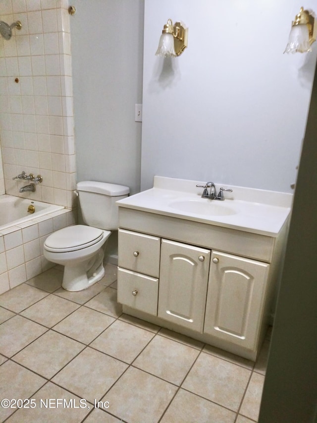 full bathroom with toilet, tiled shower / bath, tile patterned floors, and vanity