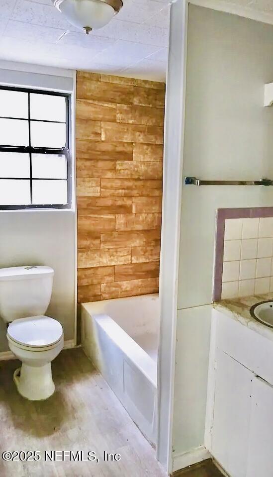 full bathroom with vanity, toilet, shower / tub combination, and wood-type flooring