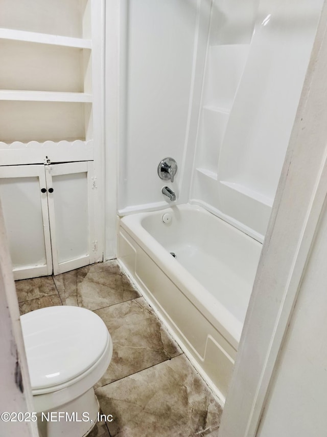 bathroom with toilet and bathtub / shower combination