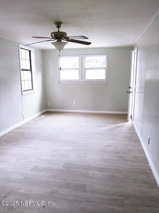 spare room with hardwood / wood-style flooring, ceiling fan, and ornamental molding