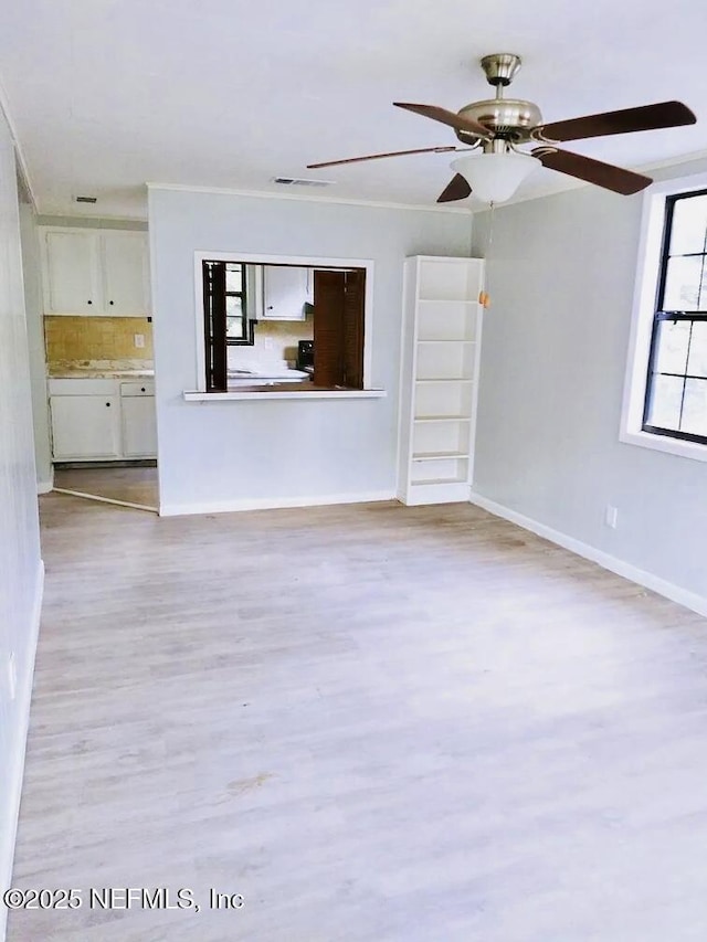 unfurnished living room featuring light wood-type flooring and ceiling fan