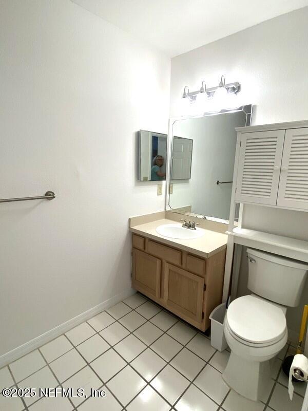 bathroom with vanity, tile patterned floors, and toilet