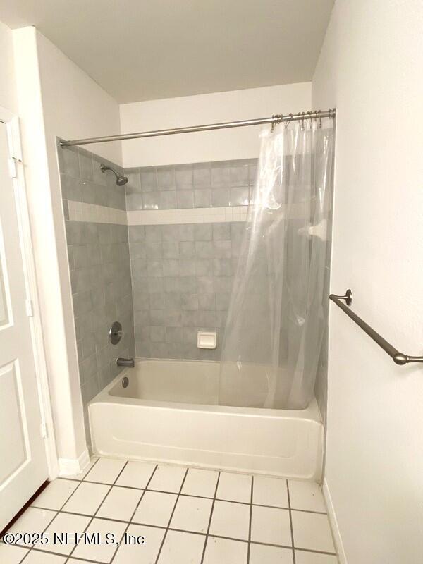 bathroom with tile patterned floors and shower / bath combination with curtain