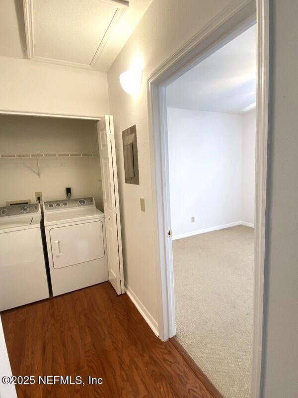 laundry room featuring dark wood-type flooring and independent washer and dryer