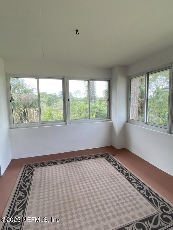 unfurnished sunroom featuring a wealth of natural light