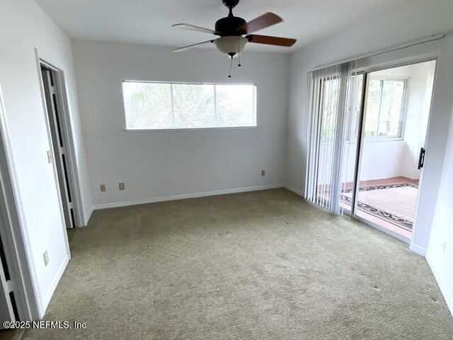 unfurnished room with light colored carpet and ceiling fan