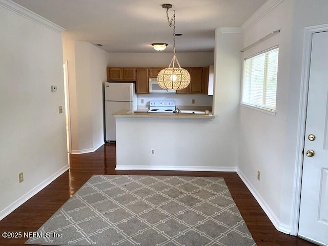 kitchen featuring dark hardwood / wood-style flooring, hanging light fixtures, kitchen peninsula, crown molding, and white appliances