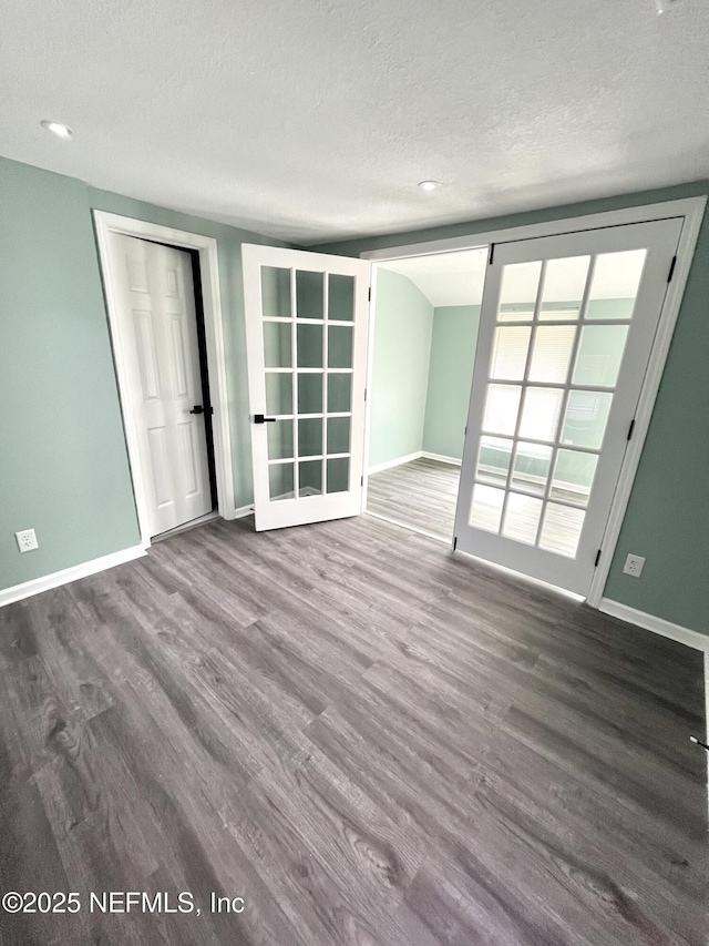 empty room with hardwood / wood-style flooring and a textured ceiling