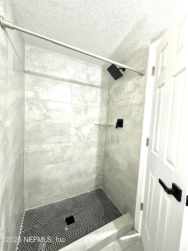 bathroom with a tile shower