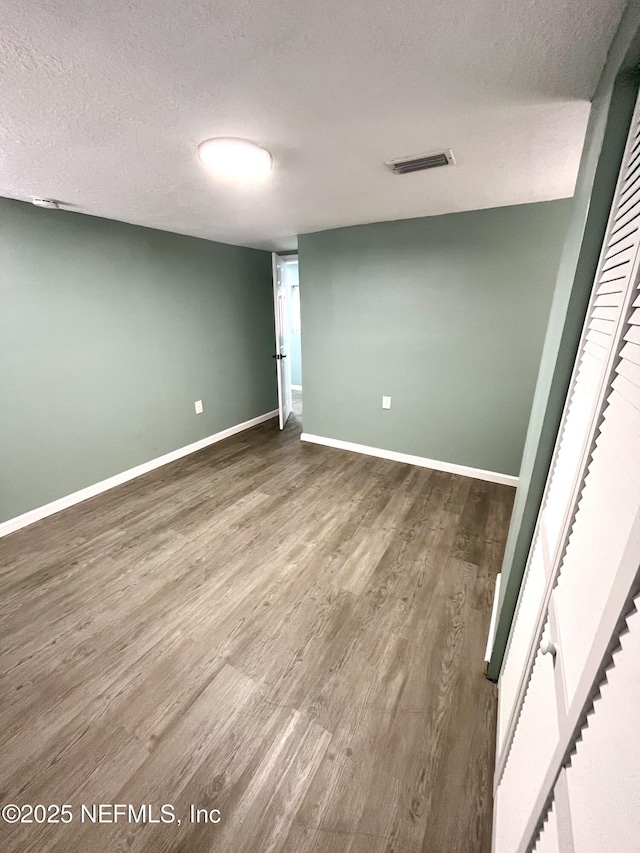 interior space featuring hardwood / wood-style floors and a textured ceiling