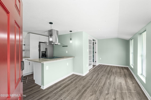 kitchen featuring island exhaust hood, white cabinets, stainless steel fridge, a peninsula, and black electric cooktop