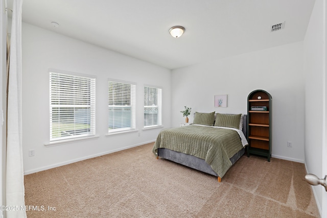 bedroom with carpet, visible vents, and baseboards