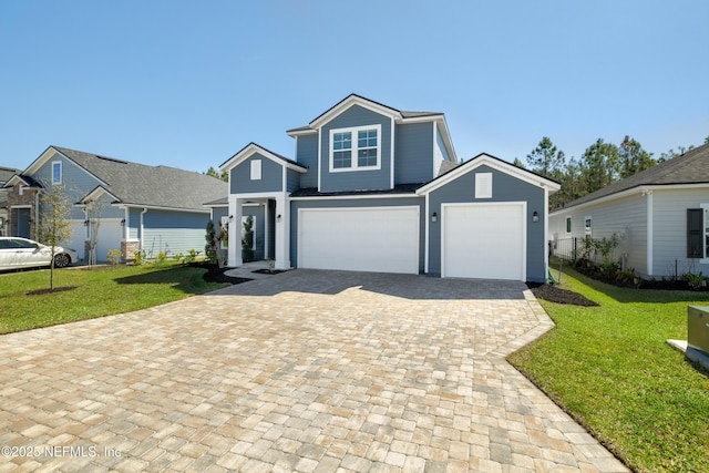 view of front of property with decorative driveway, a garage, and a front yard