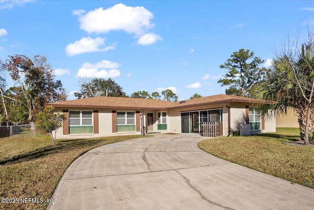 ranch-style home with a front lawn