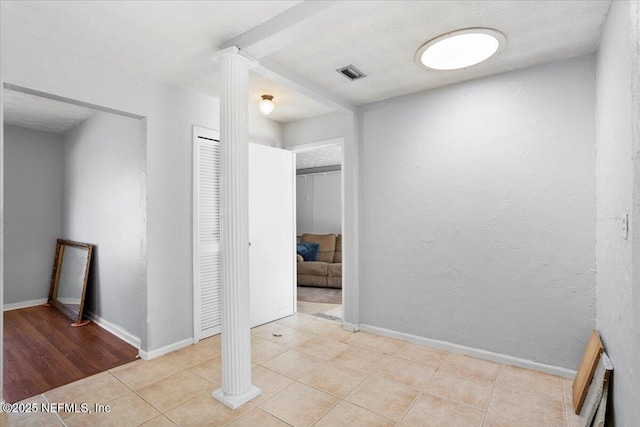 interior space with ornate columns and light tile patterned floors