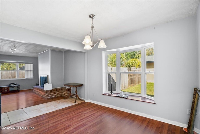 interior space with a notable chandelier and tile patterned floors