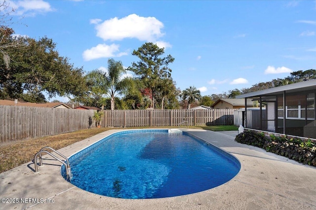 view of swimming pool featuring a sunroom and a patio