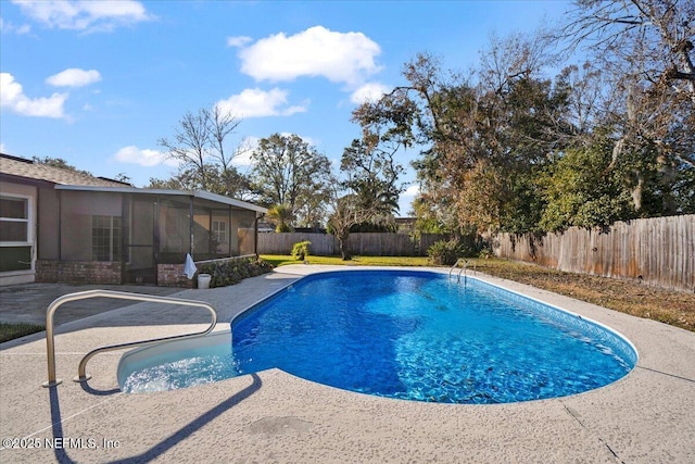 view of pool with a sunroom and a patio